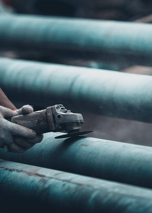 PMW worker among stacked pipes
