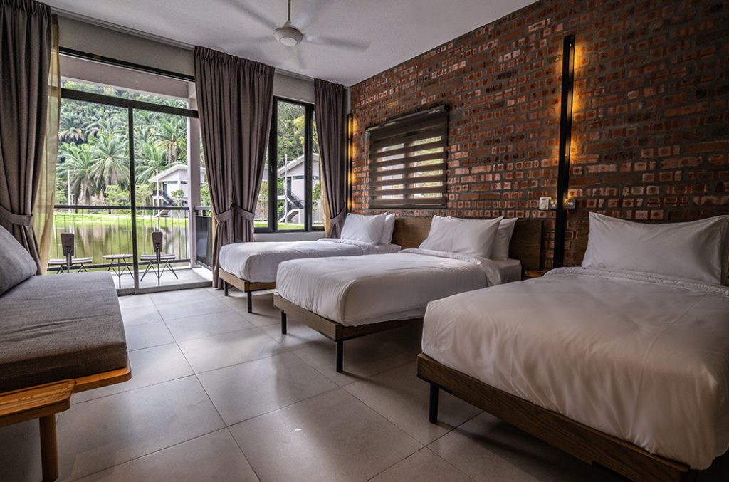 Twin bedroom at Sementra with a brick wall and garden view